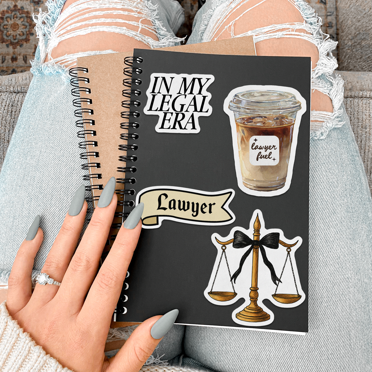 Notebook titled 'In My Legal Era Lawyer' held by a person with司法相关的图标