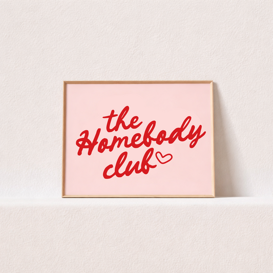 Framed artwork with 'the Homebody club' text on a light pink background