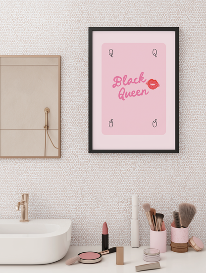 Pink Black Queen wall art print in black frame above bathroom sink with makeup decor