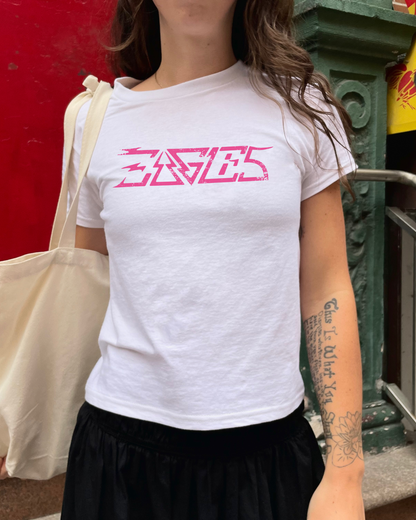 White classic rock Eagles band shirt with pink logo worn outdoors with tote bag