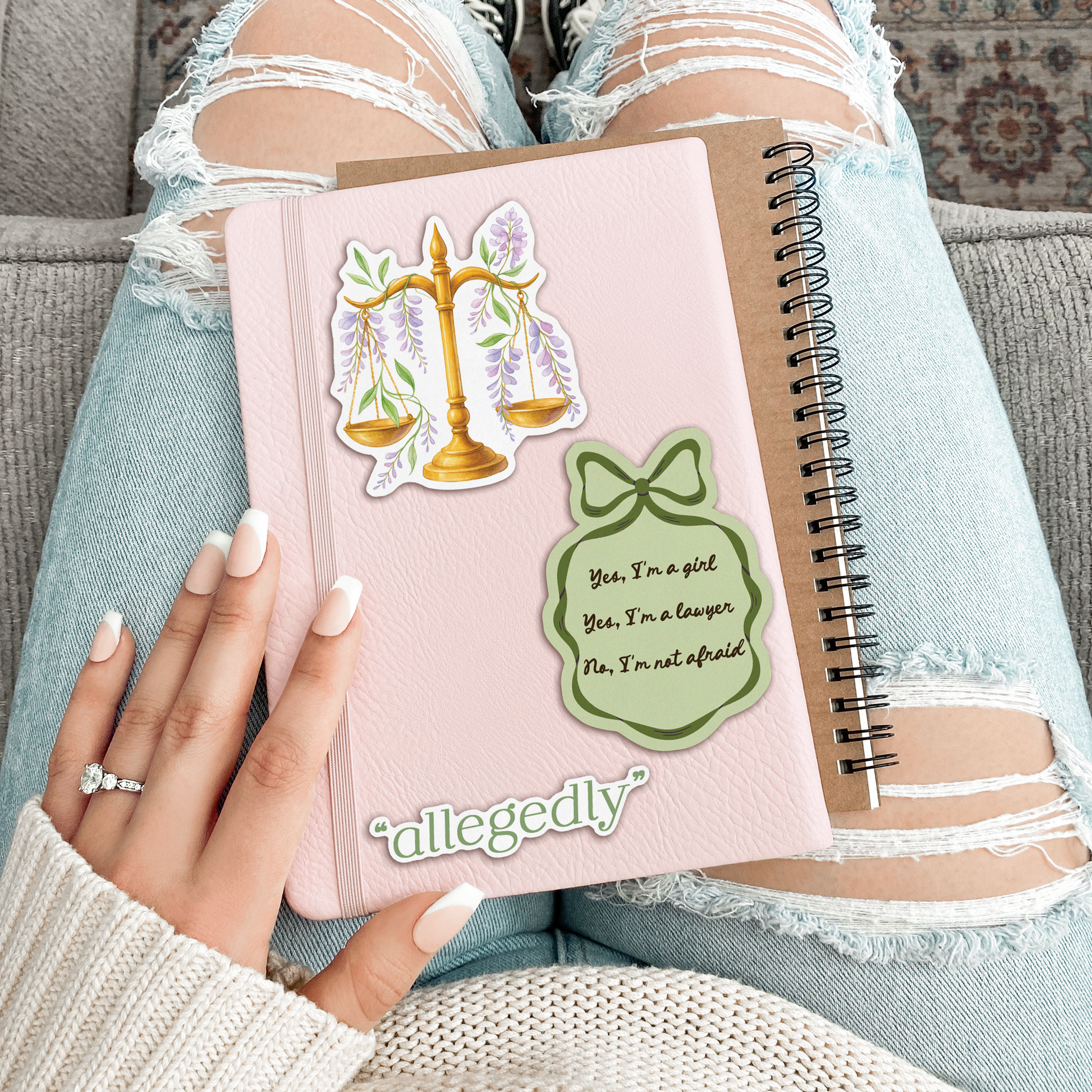 Person holding a pink notebook with stickers